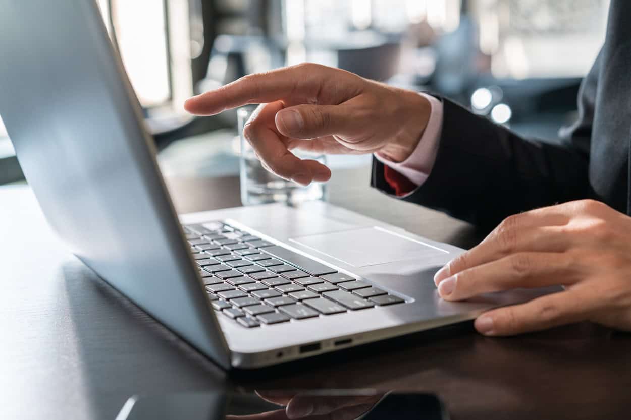 Man pointing at laptop screen