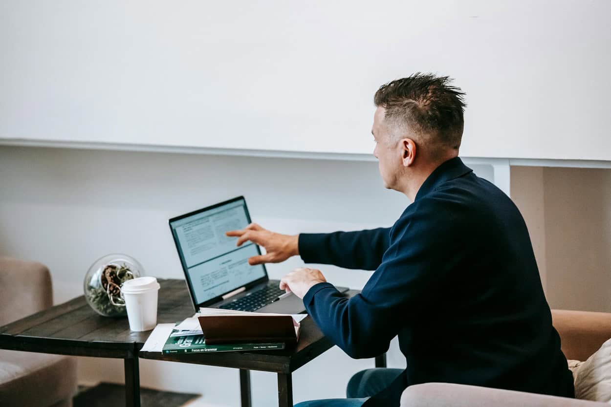 Director working on laptop after receiving penetration test to identify vulnerabilities