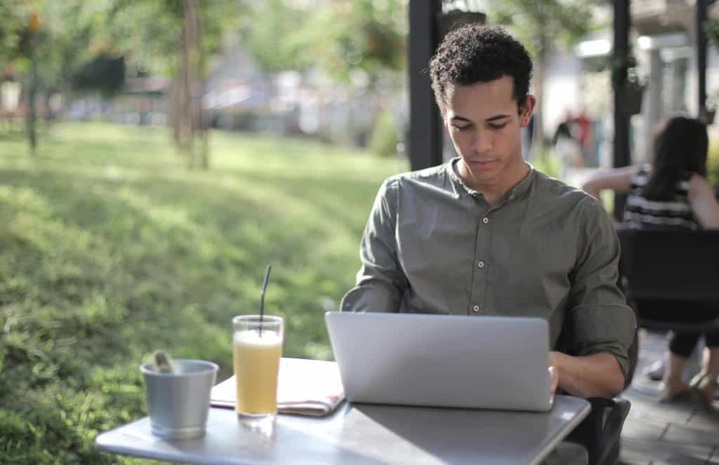 Man using laptop outside